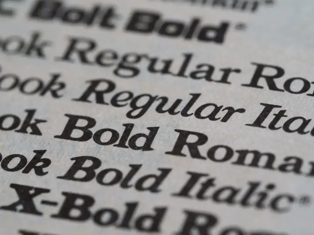 Macro shot of deeply debossed serif typography on thick textured cotton paper