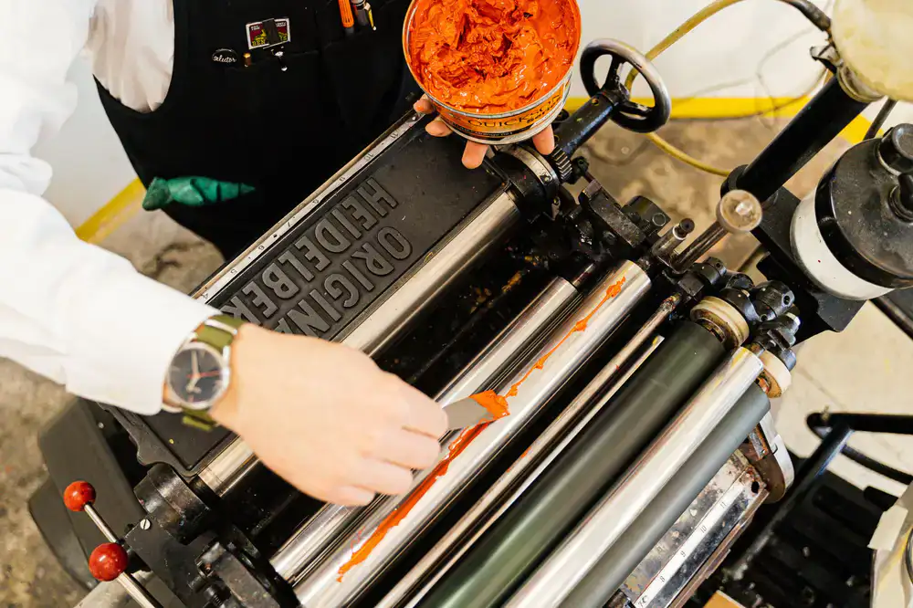 A photopolymer letterpress plate being aligned on the press bed